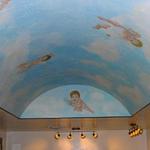 A long vaulted ceiling space with cherubs.