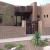 Beautiful entryway with faux bronze plates above door and gates to match.